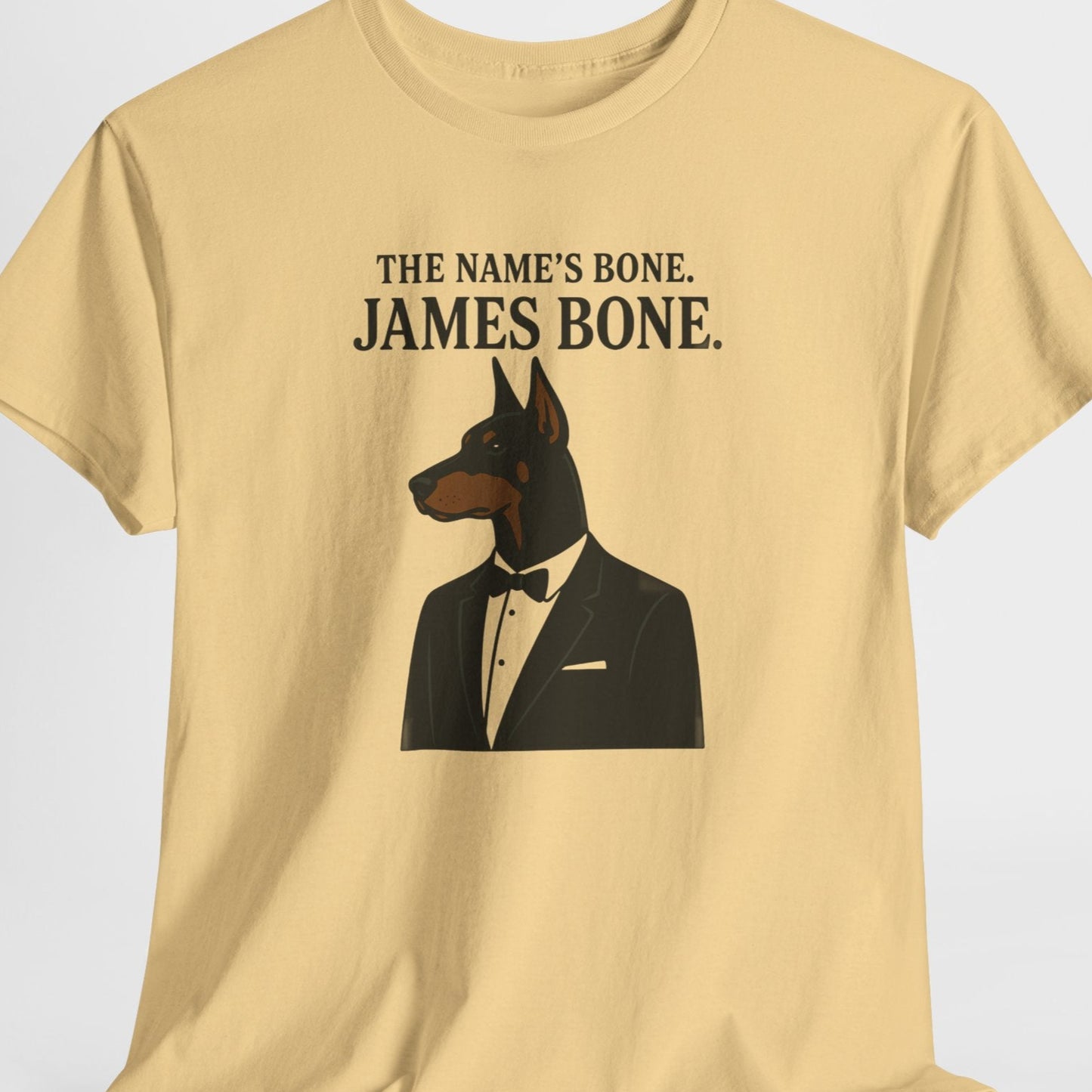 Beige t-shirt with a dog in a suit graphic and text on a white background