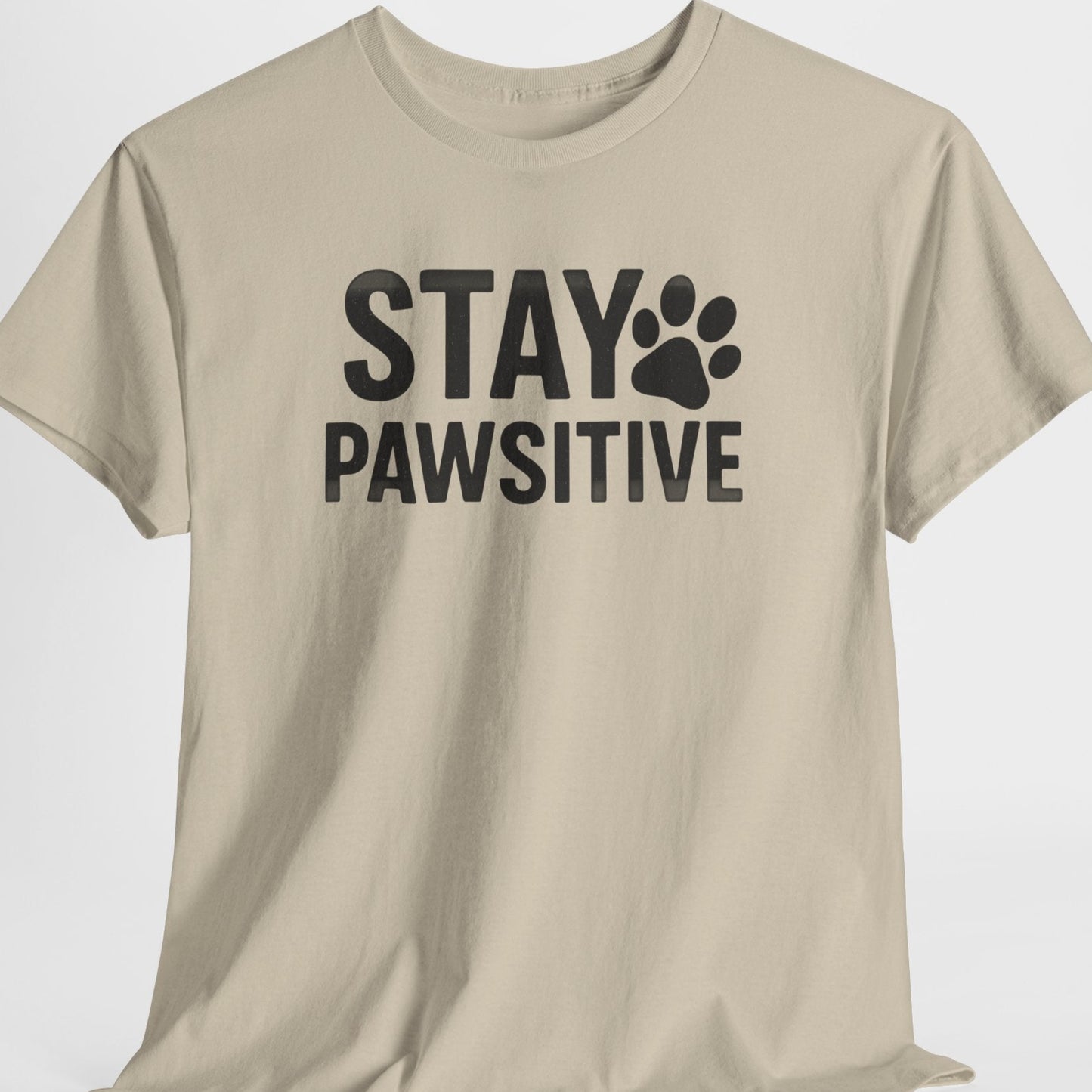 Beige t-shirt with 'Stay Pawsitive' text on a white background