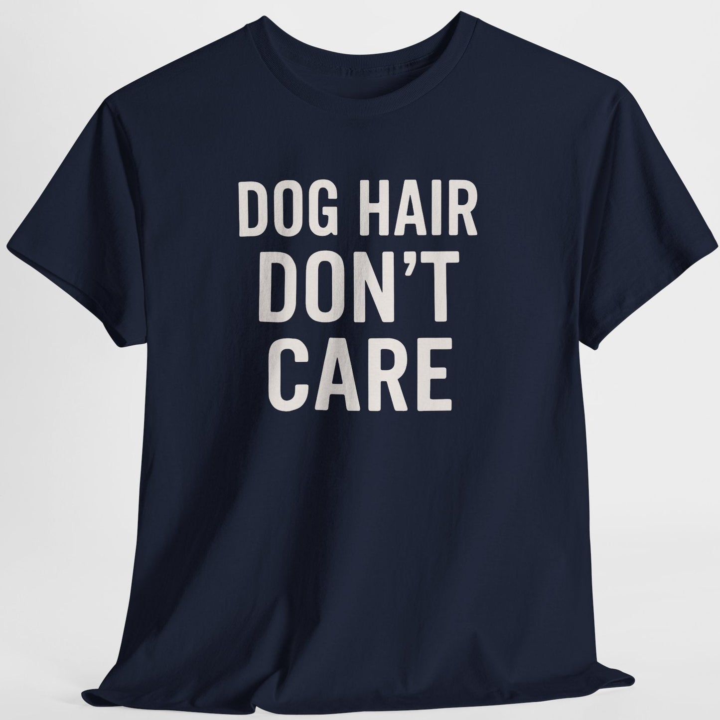Navy blue t-shirt with 'DOG HAIR DON'T CARE' text on a light gray background
