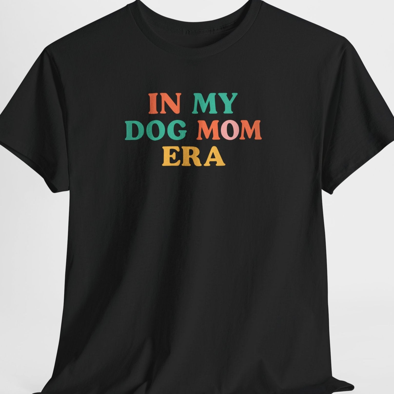 Black t-shirt with colorful text 'IN MY DOG MOM ERA' on a light gray background