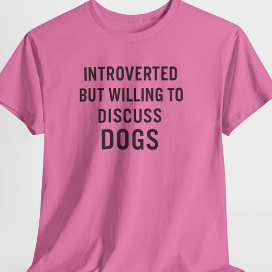 Pink t-shirt with text 'Introverted but willing to discuss dogs' on a white background