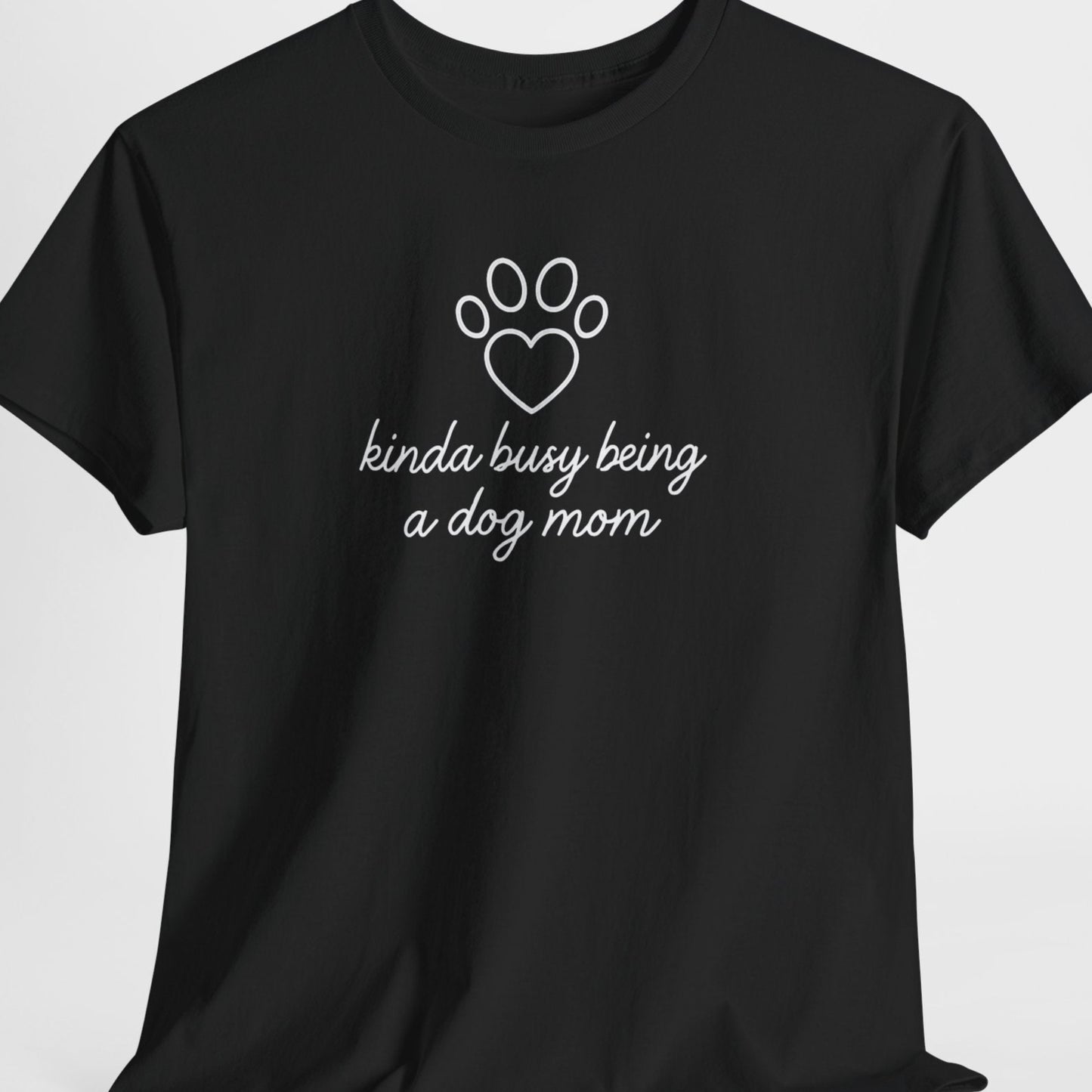 Black t-shirt with white text and paw print design on a light gray background