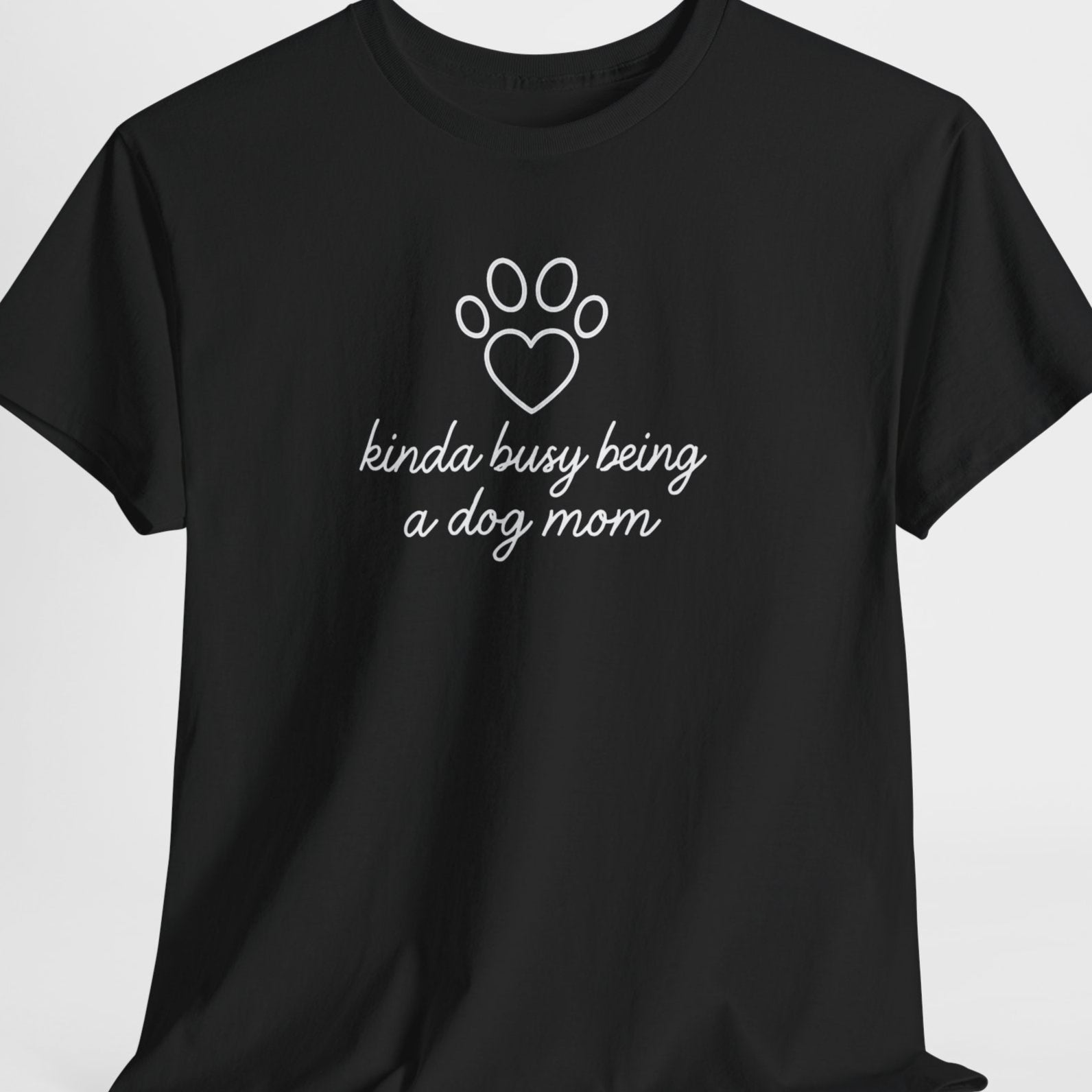 Black t-shirt with white text and paw print design on a light gray background