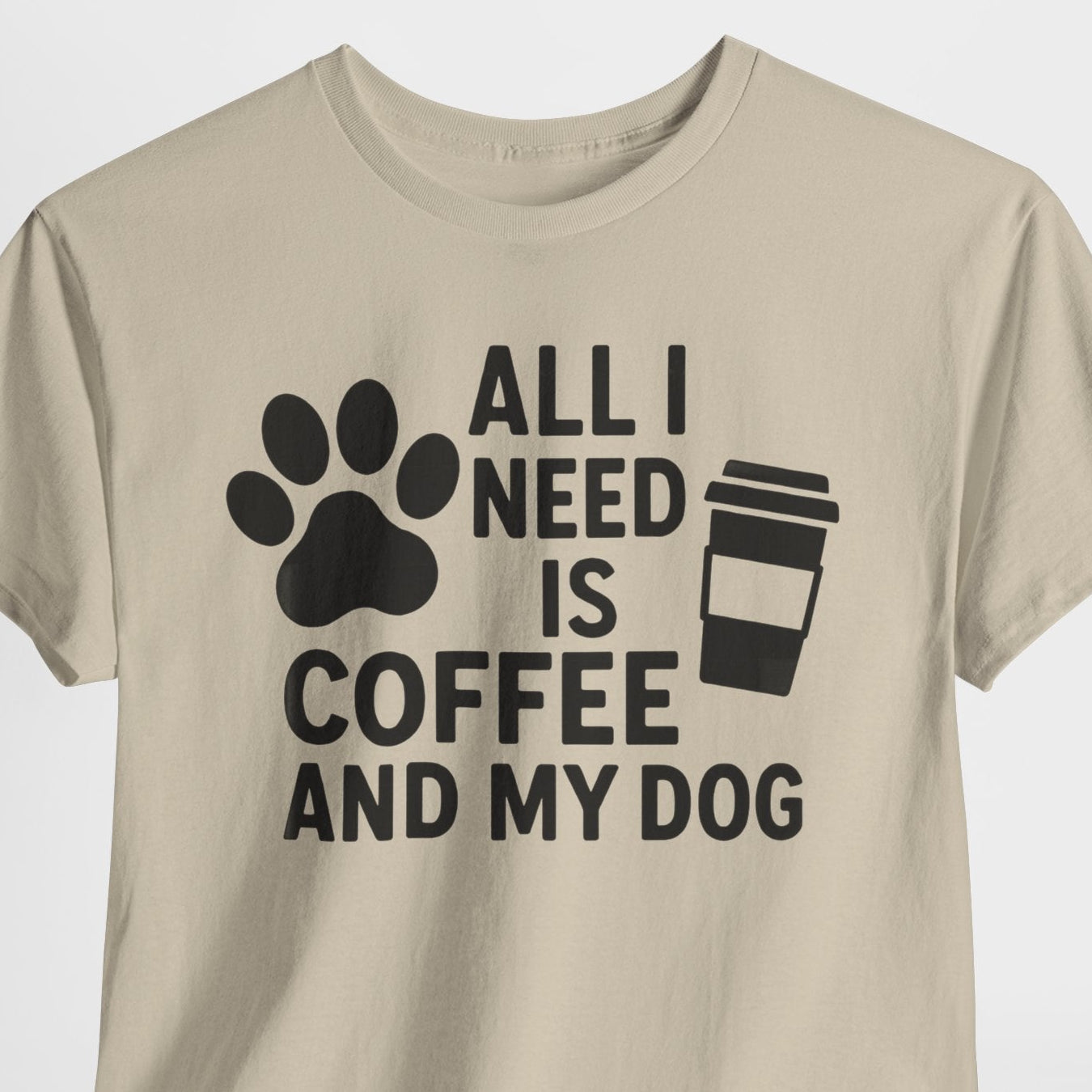Beige t-shirt with text 'All I Need is Coffee and My Dog' on a white background