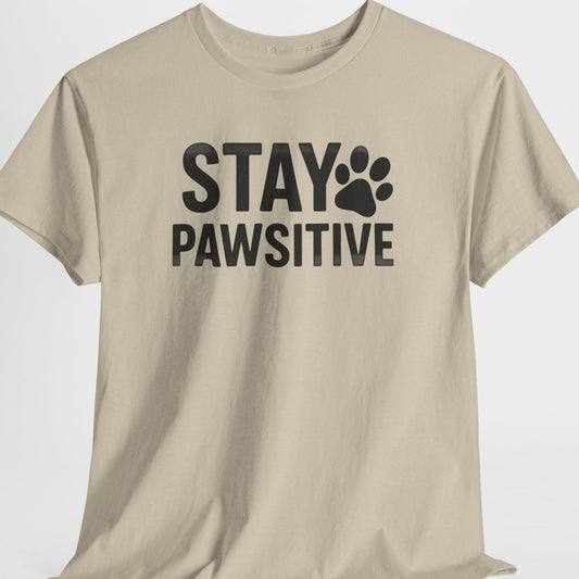 Beige t-shirt with 'Stay Pawsitive' text on a white background