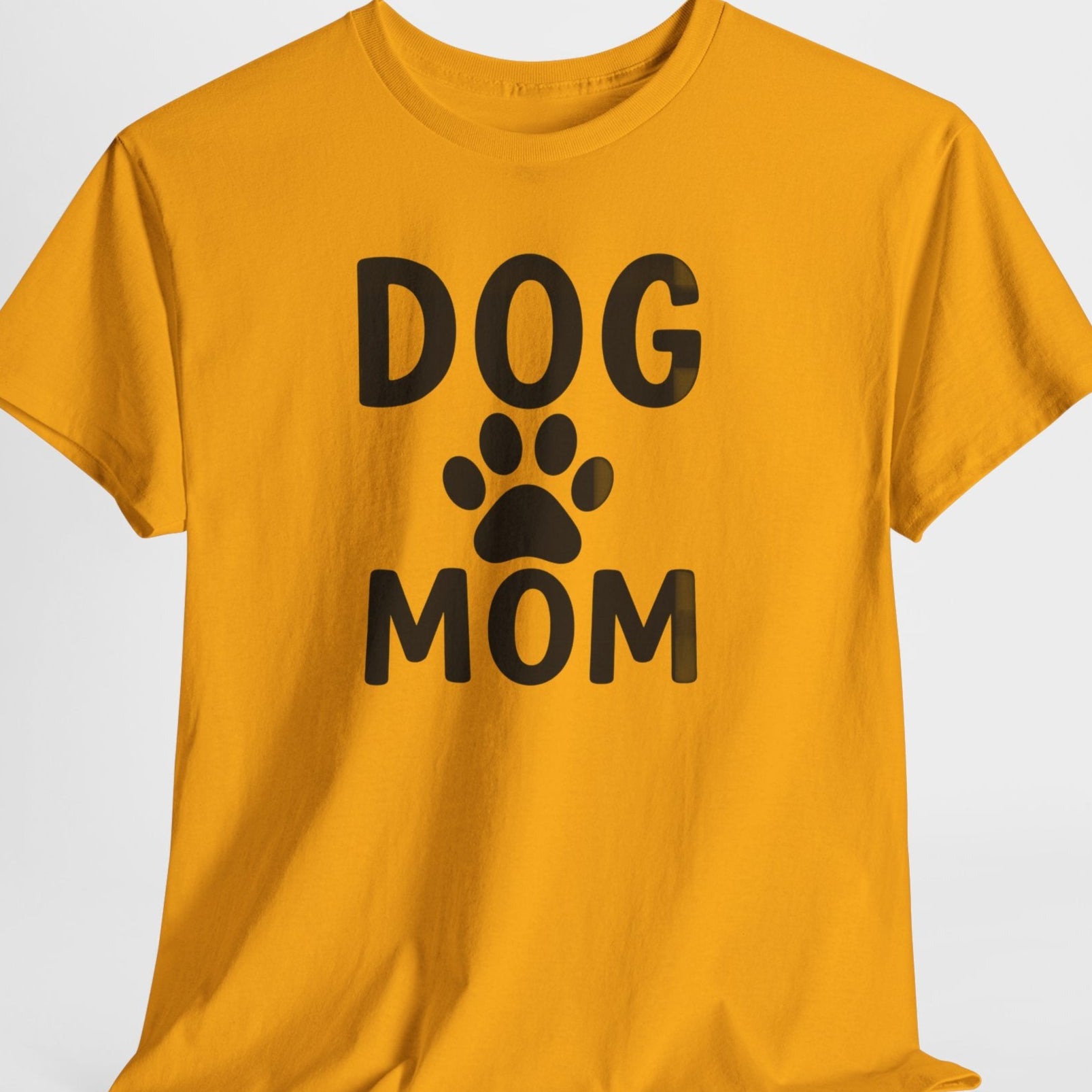 Yellow t-shirt with 'DOG MOM' text and paw print on a white background