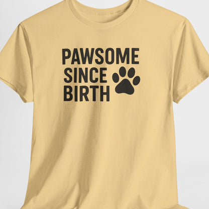 Beige t-shirt with 'PAWSOME SINCE BIRTH' text and paw print on a light gray background