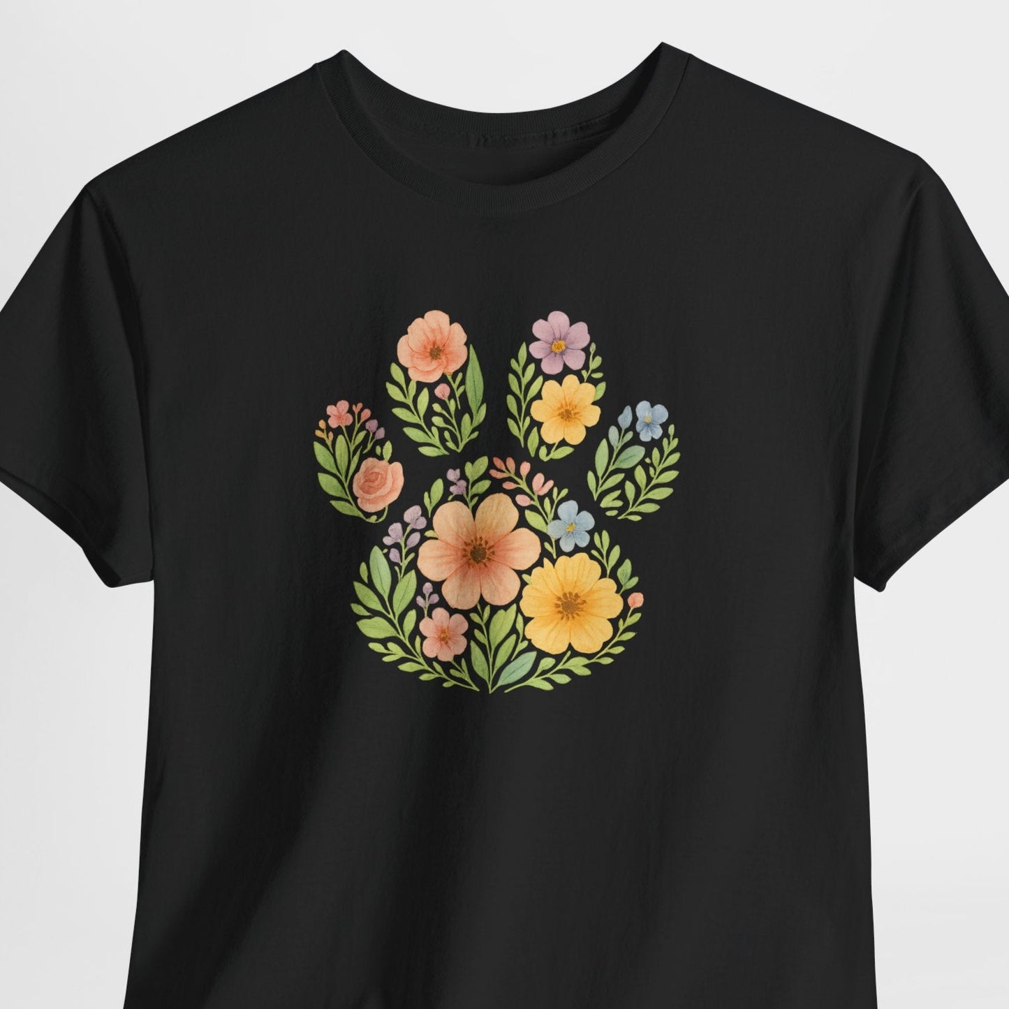 Black t-shirt with floral paw print design on a white background