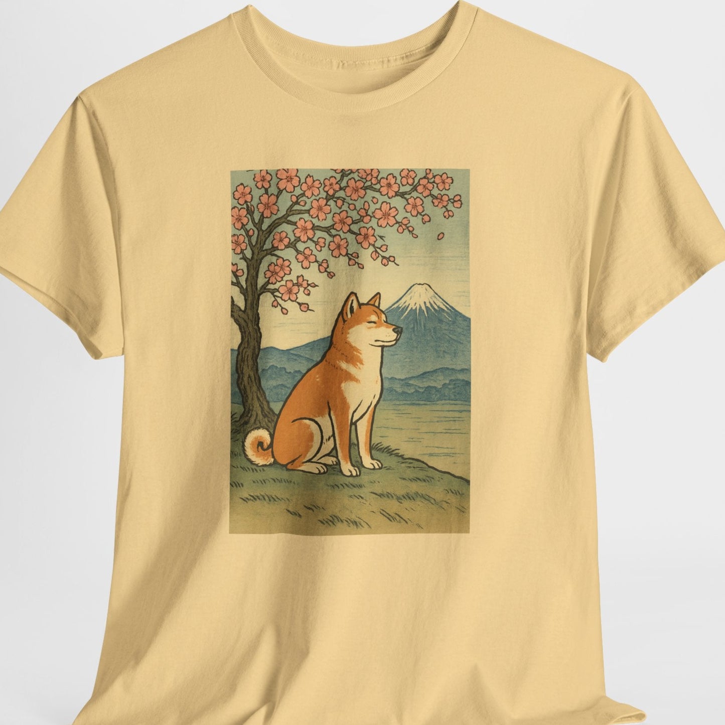 Beige t-shirt with a dog and cherry blossom tree graphic on a white background