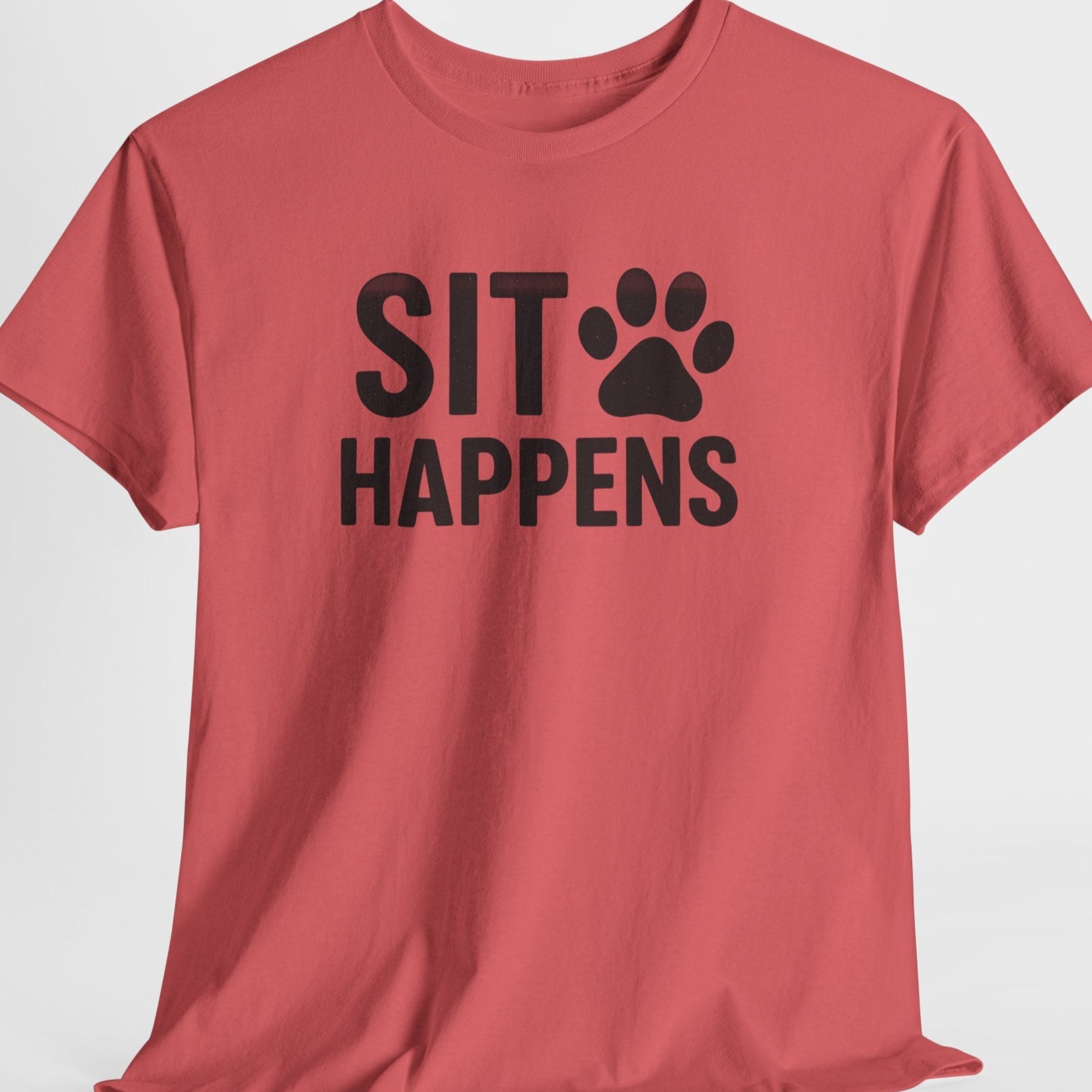 Red t-shirt with 'SIT HAPPENS' text and paw print on a light gray background