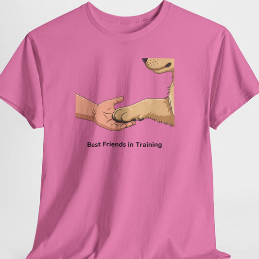 Pink t-shirt with a graphic of a hand shaking a dog's paw and text 'Best Friends in Training' on a white background.
