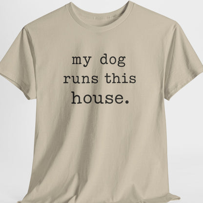 Beige t-shirt with 'my dog runs this house' text on a white background