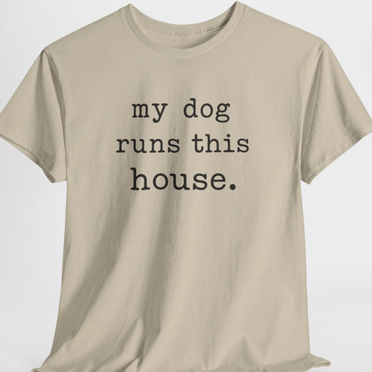 Beige t-shirt with 'my dog runs this house' text on a white background
