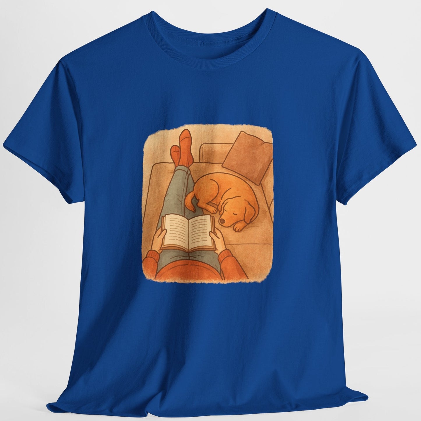 Blue t-shirt with a graphic of a person reading a book to a cat on a white background