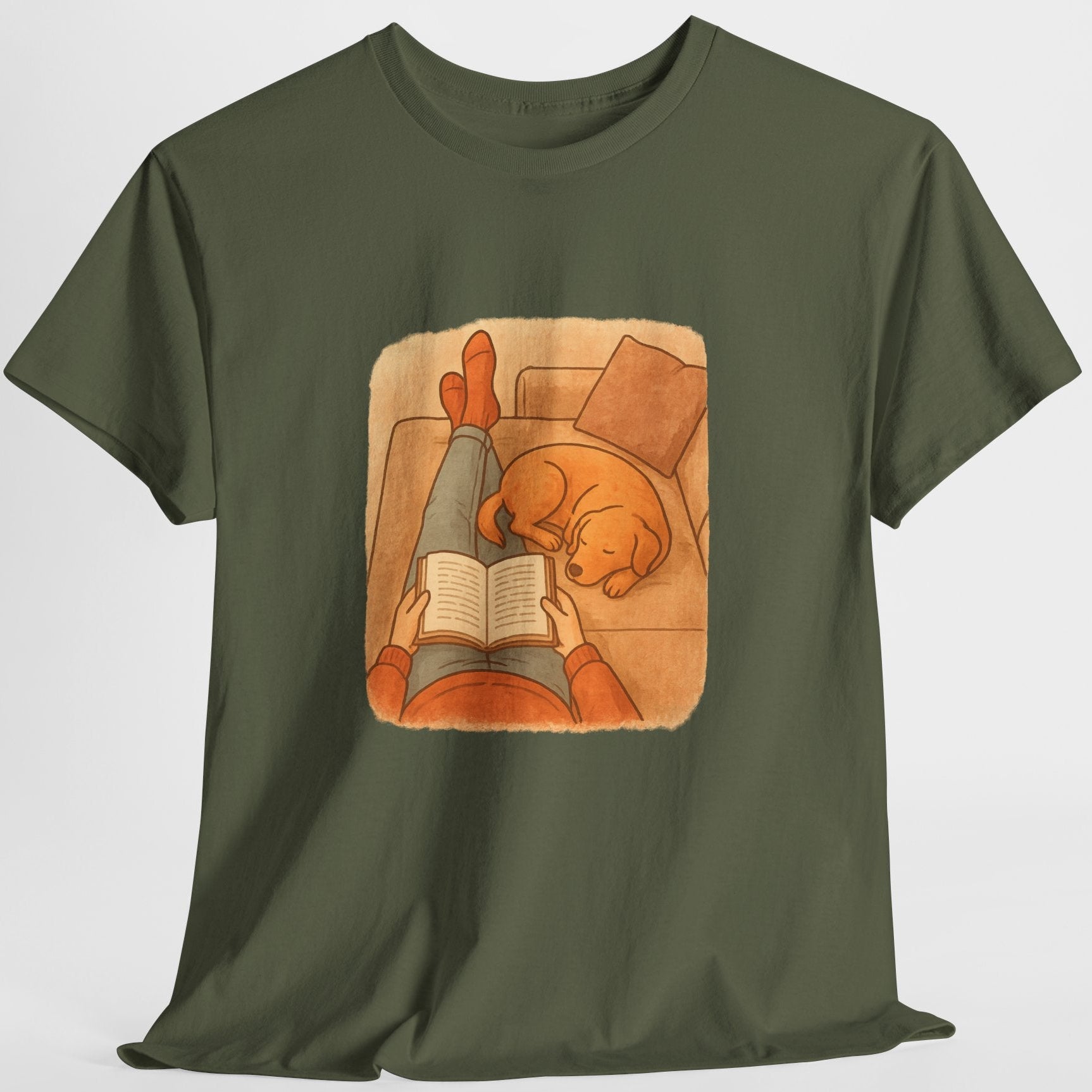 Green t-shirt with a graphic of a person reading a book to a dog on a white background