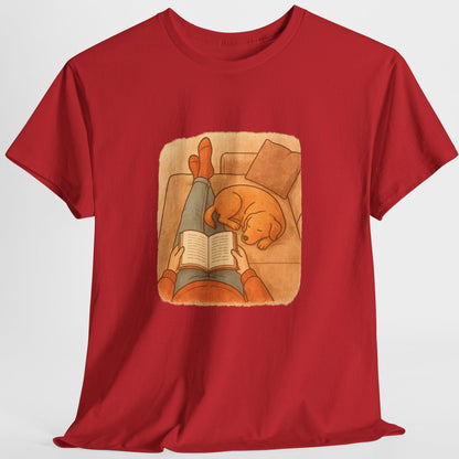 Red t-shirt with a graphic of a person reading a book to a dog on a white background
