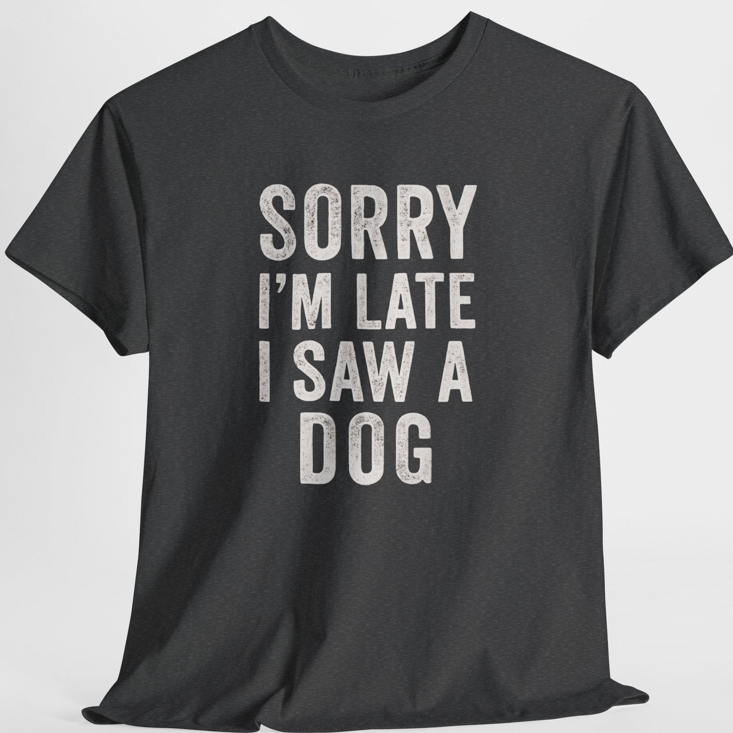 Black t-shirt with white text 'Sorry I'm late I saw a dog' on a light gray background