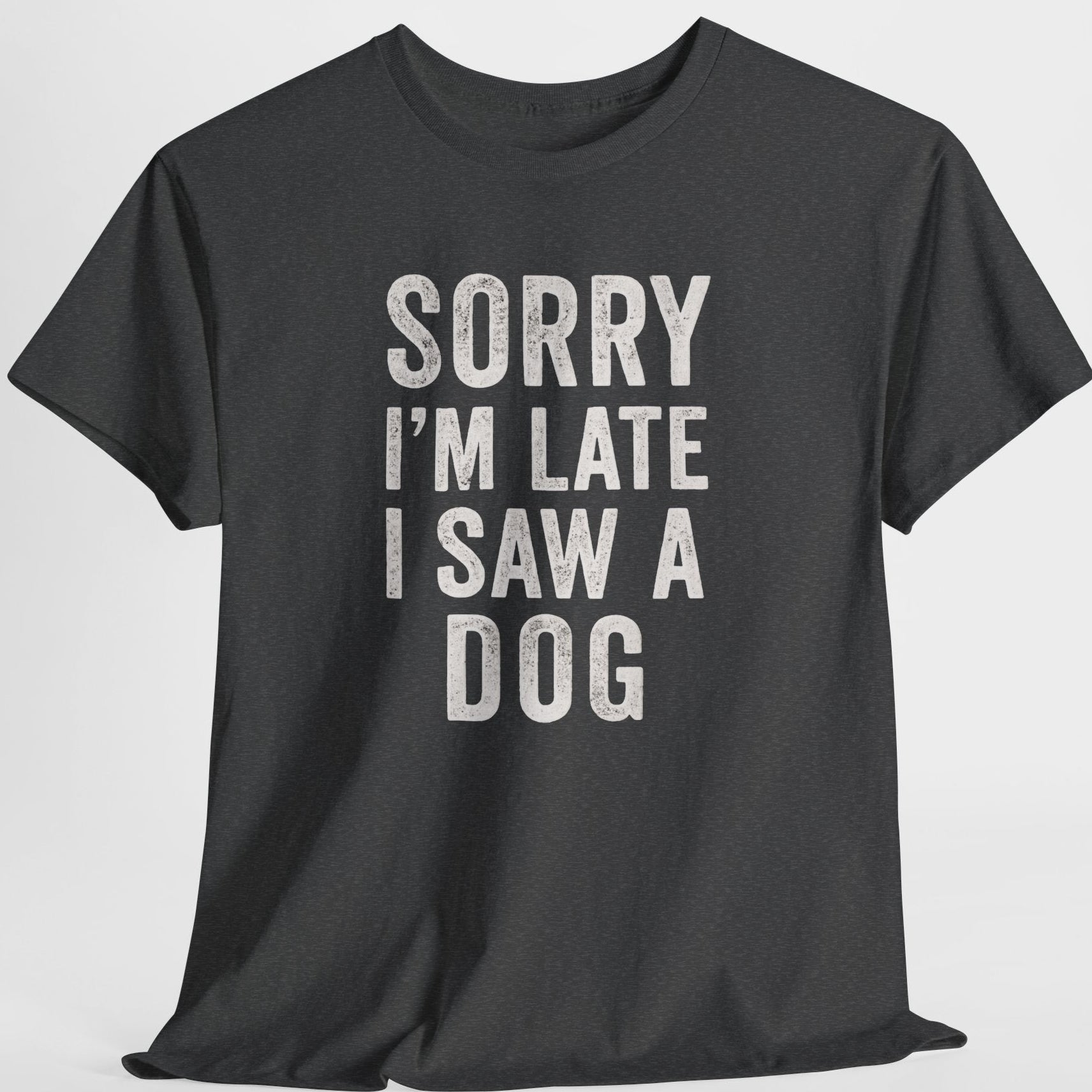 Black t-shirt with white text 'Sorry I'm late I saw a dog' on a light gray background